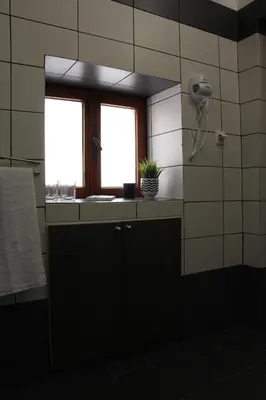 a bathroom with a window and a sink and a shower at Evanthea Residence in Kounoupidhianá