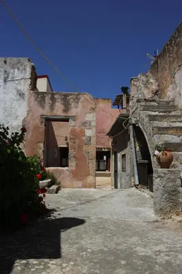 an alley in an old stone building with a doorway at Evanthea Residence in Kounoupidhianá