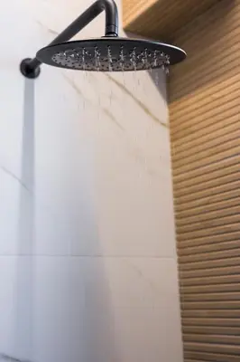 a shower head hanging from a wall in a bathroom at Orama Luxury Apartments in Agia Marina Nea Kydonias