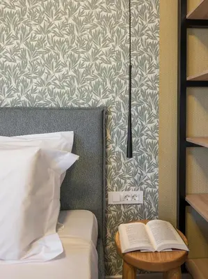 a bedroom with a bed and a table with a book at Orama Luxury Apartments in Agia Marina Nea Kydonias