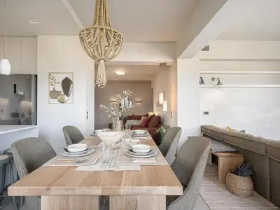 a dining room with a wooden table and chairs at Emmanuel's Sea View Luxury Apartment in Kissamos