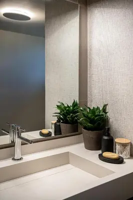 a bathroom with a sink and two potted plants at Emmanuel's Sea View Luxury Apartment in Kissamos