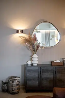 a vase on a dresser in a room with a mirror at Emmanuel's Sea View Luxury Apartment in Kissamos