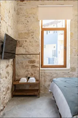 a bedroom with a bed and a window at PETRA - casa casa group in Chania Town