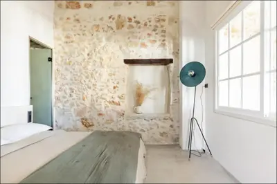 a bedroom with a bed and a blue floor lamp at PETRA - casa casa group in Chania Town