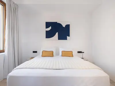 a bedroom with a white bed with two yellow pillows at ALS - casa casa group in Chania Town
