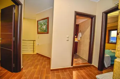 a room with a hallway with a bathroom and a bedroom at Villa Archontissa in Análipsis