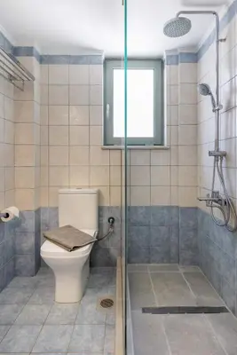 a bathroom with a toilet and a shower at Blue Port in Chania in Souda