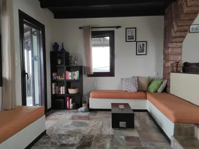 a living room with a couch and a table at Villa Chloe - Amazing view Villa with swimming pool in Chania Town