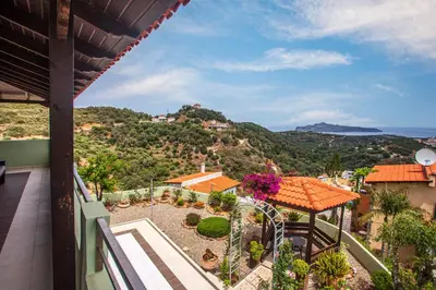 a view from the balcony of a house with a roller coaster at Villa Chloe - Amazing view Villa with swimming pool in Chania Town