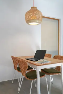 a dining room table with a laptop computer on it at Lindas Convent Garden Home 1 in Chania Town