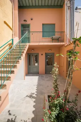 a house with a staircase and a balcony at Lindas Convent Garden Home 1 in Chania Town