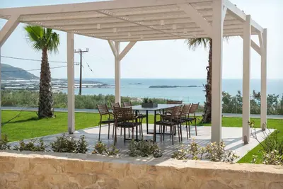 a patio with a table and chairs under a pavilion at Actea Seaview Villas I 