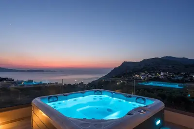 a jacuzzi tub in a room with a view at Villa Ekphrasis with sea view and jacuzzi in Ravdhoúkha