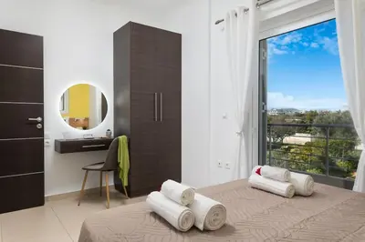 a bedroom with a bed with towels on it at New cozy apartment near the center of Chania in Chania Town