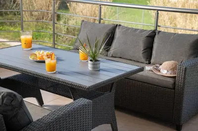 a patio table with a couch and orange juice at New cozy apartment near the center of Chania in Chania Town