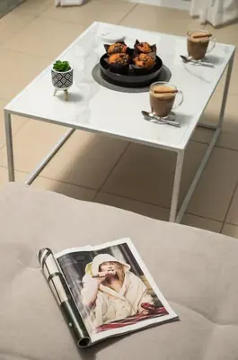 a magazine sitting on a table with a plate of food at New cozy apartment near the center of Chania in Chania Town