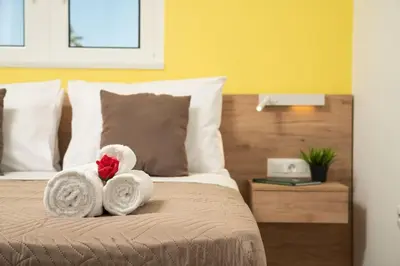 a bedroom with a bed with towels on it at New cozy apartment near the center of Chania in Chania Town