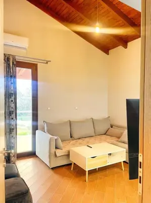 a living room with a couch and a table at Kathiana cozy apartment in Kathiana