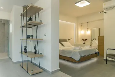 a bedroom with a bed and a shelf in a room at The Alcove Studio Chania in Chania Town