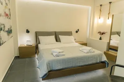 a bedroom with a bed with two towels on it at The Alcove Studio Chania in Chania Town