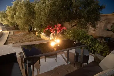 a table with a candle on top of a patio at The Alcove Studio Chania in Chania Town