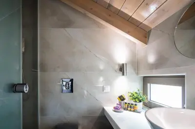 a bathroom with a sink and a mirror at Oinolithos Luxury Villas in Kalamaki Chanion