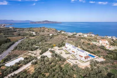 an aerial view of a villa on a hill next to the ocean at Oinolithos Luxury Villas in Kalamaki Chanion