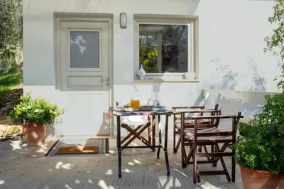 a table and chairs sitting on a patio at DOLONAS Cosy House in Aliyoí