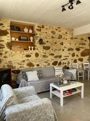 a living room with a couch and a table at DOLONAS Cosy House in Aliyoí
