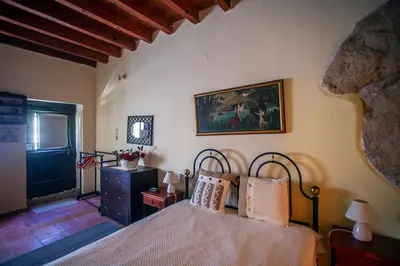 a bedroom with a bed and a painting on the wall at Villa Polirinia in Kissamos