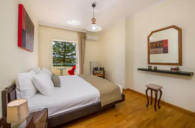 a hotel room with a bed and a mirror at Be Crete - vista Lazareta in Chania Town