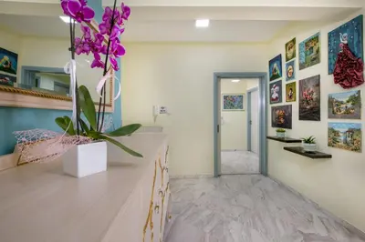 a room with a vase of purple flowers on a counter at Be Crete - vista Lazareta in Chania Town