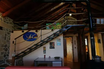 a staircase in a room with a table in a room at Elpida Country House -Paleochora-Anidri in Palaiochóra