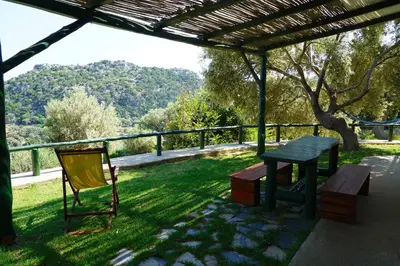 a picnic table and a chair under a pergola at Elpida Country House -Paleochora-Anidri in Palaiochóra