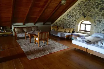 a large living room with a stone wall at Elpida Country House -Paleochora-Anidri in Palaiochóra