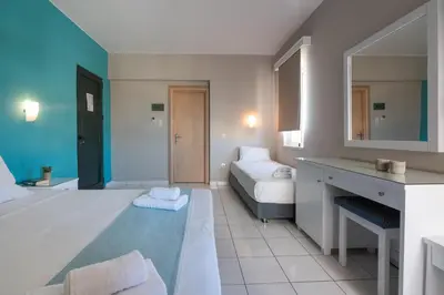 a bedroom with a large bed and a bathroom at Hermes Hotel in Kissamos