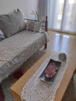 a living room with a couch and a tray of food at EMMY APARTMENT in Chania Town