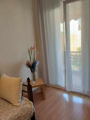 a living room with a vase of flowers on a table at EMMY APARTMENT in Chania Town