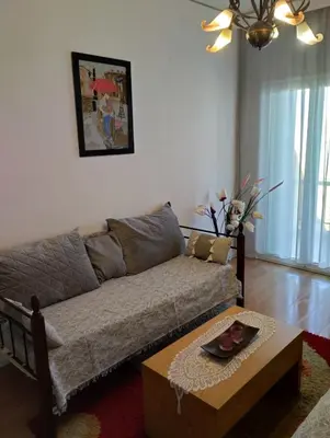 a living room with a couch and a coffee table at EMMY APARTMENT in Chania Town