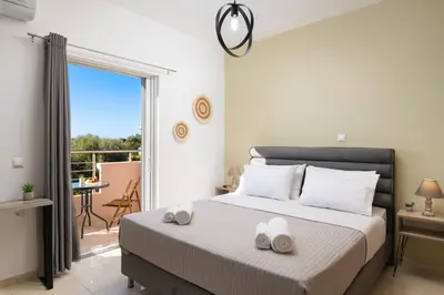 a bedroom with a bed with two towels on it at The Cozy Nook in Chorafakia