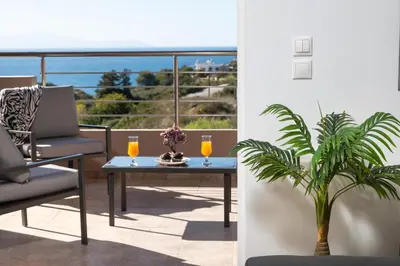 a patio with a table and a chair and a plant at The Cozy Nook in Chorafakia