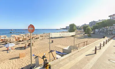 a bike parked next to a beach with chairs and umbrellas at Sun Beach Apartment in Chania 15 in Chania Town