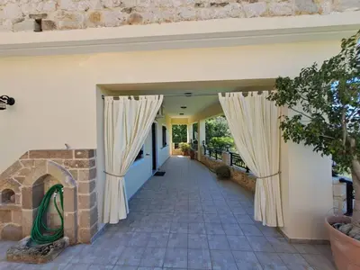 an entrance to a house with drapes on the door at Falasarna's Sunset Home in Falasarna