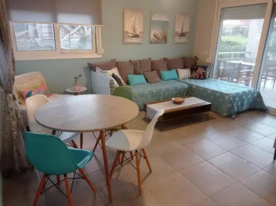 a living room with a couch and a table and chairs at Nostalgico cottage in Chania Town