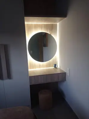 a bathroom with a round mirror and a sink at Nostalgico cottage in Chania Town