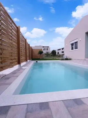 a swimming pool in the backyard of a house at Nostalgico cottage in Chania Town