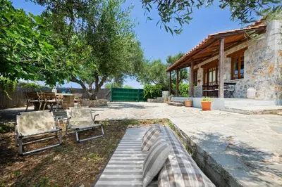 a patio with a bench and a house at Fortino Villa in Chorafakia