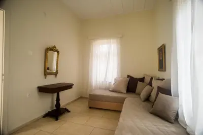 a living room with a couch and a mirror at Tatiana's Garden House in Chania Town