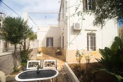 a table and chairs in front of a building at Tatiana's Garden House in Chania Town